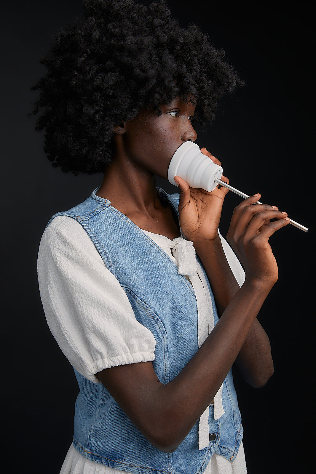 woman using voice straw and cup to warm up