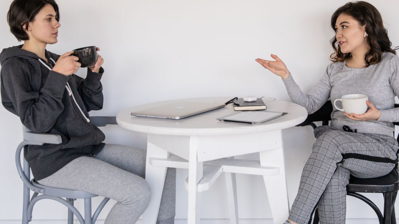 two women sitting and chatting about voice straw