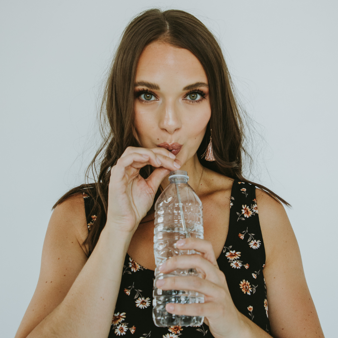 woman using voice straw in water bottle